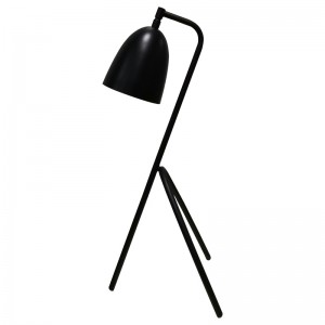 Stolní lampa třinohy s černým povrchem a přepínačem rockeruna linii v pokoji